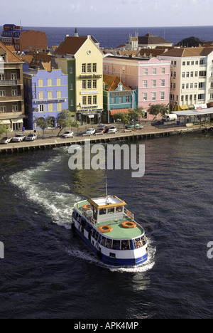 Willemstad's Punda waterfront pastel Dutch architecture with ferry for pedestrians crossing Sint Ana Baai entrance Stock Photo