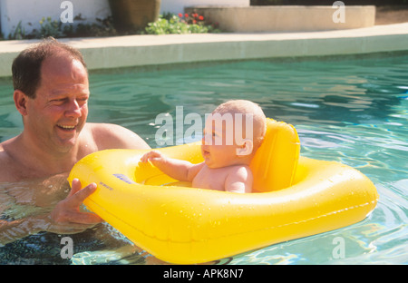 Father & baby boy in swimming pool Stock Photo