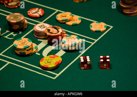 Dice and chips on a craps table in Las Vegas Nevada Caesars Palace and Casino Stock Photo