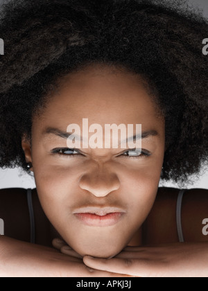 Portrait of young woman grimacing, close up Stock Photo - Alamy