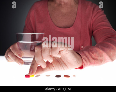 Woman taking pill (close-up) Stock Photo