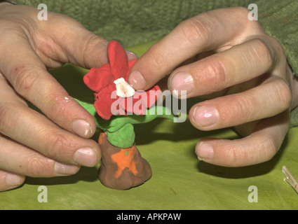 kids tinker flowers of modeling clay Stock Photo