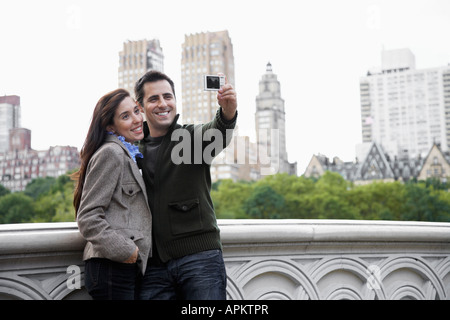 Couple photographing themselves Stock Photo