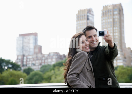 Couple photographing themselves Stock Photo