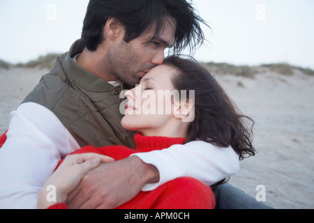 Young couple hugging on beach Stock Photo