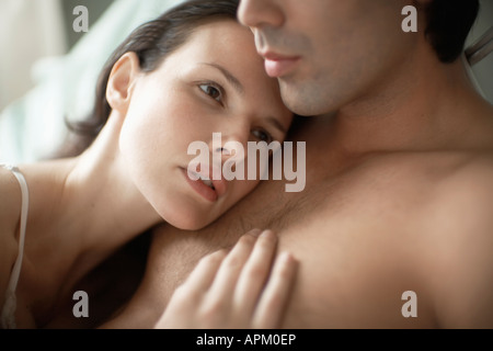 Woman resting head on man's chest Stock Photo