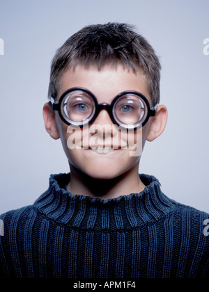 Portrait of a goofy young boy wearing thick glasses Stock Photo