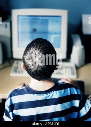rear view of a child using a computer Stock Photo