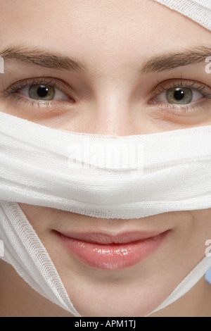 Bandage around woman's face, close-up Stock Photo