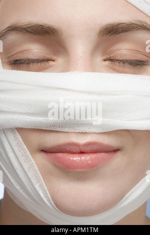 Bandage around woman's face, close-up Stock Photo