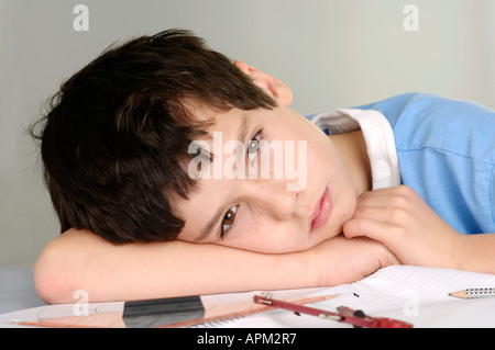 Boy tired from doing his homework Stock Photo