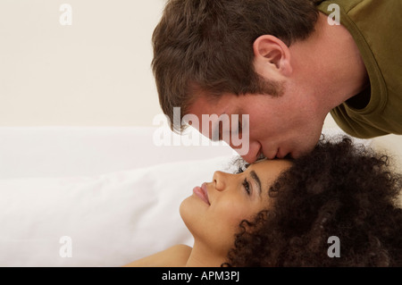Man kissing woman on forehead Stock Photo