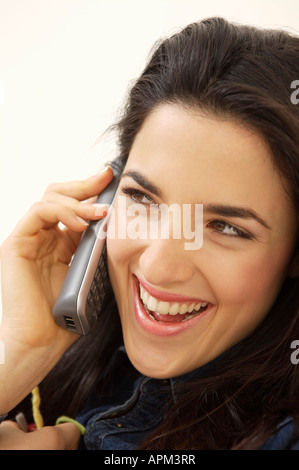 Woman laughing and talking by telephone Stock Photo