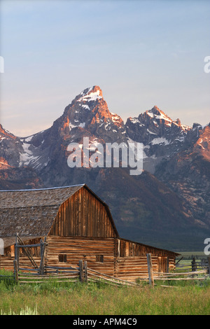 Old barn and sage brush below the Grand Teton in early morning Grand Teton National Park Teton County Wyoming USA Stock Photo