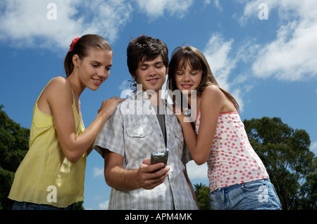 Teenagers using electronic agenda and celullar phone Stock Photo