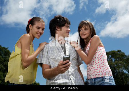 Teenagers using electronic agenda and celullar phone Stock Photo