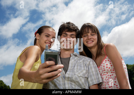 Teenagers using electronic agenda and celullar phone Stock Photo