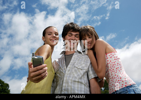 Teenagers using electronic agenda and celullar phone Stock Photo