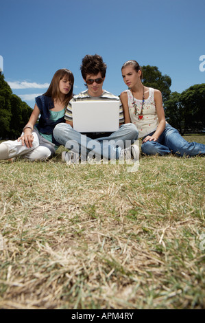 Three teenagers with notebook Stock Photo