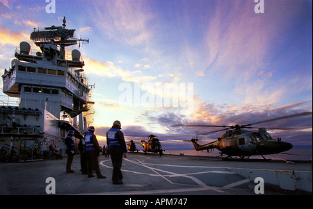 The Royal Navy aircraft carrier HMS Invincible in the amphibious role with Lynx and Seaking 4 Helicopters on deck Stock Photo