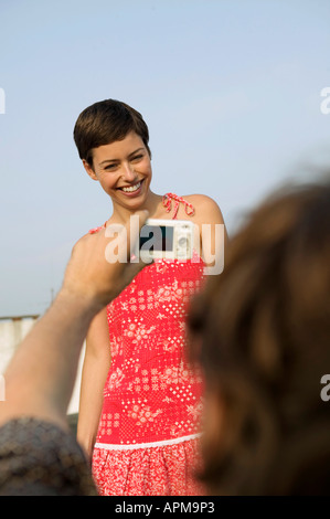 Man photographing young woman Stock Photo