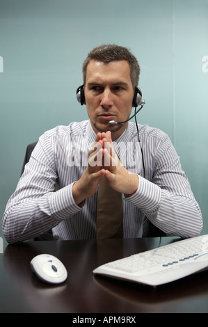 Businessman talking through telephone headset Stock Photo