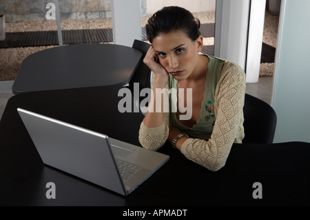 Tired and bored woman at the office Stock Photo