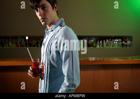 Man with a drink in a bar Stock Photo