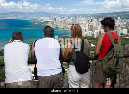 Backpack visitors view Waikiki Beach and Honolulu city from top of Diamond Head Oahu Hawaii USA Stock Photo