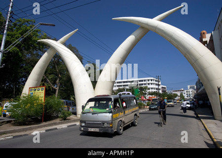 Road traffic passes elephant tusk road arch Mombasa Kenya Stock Photo