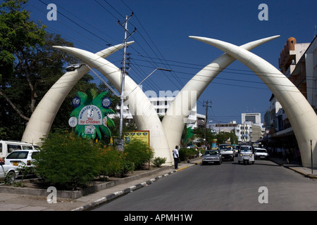 Road traffic passes elephant tusk road arch Mombasa Kenya Stock Photo