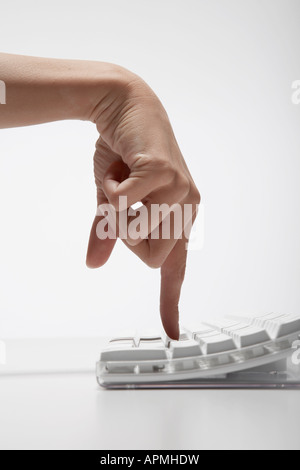 Young woman typing with index finger (close-up) Stock Photo