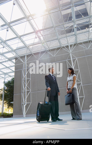 Two businesspeople talking in lobby (low angle view) Stock Photo
