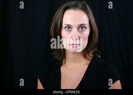 Young brunette woman with emotionless cold unfeeling stoic Stock Photo ...