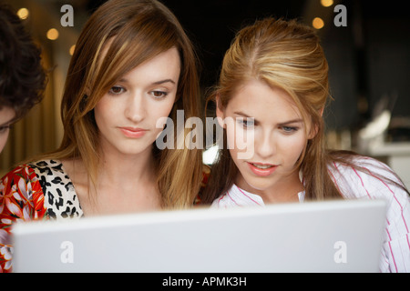 Two young women using laptop Stock Photo