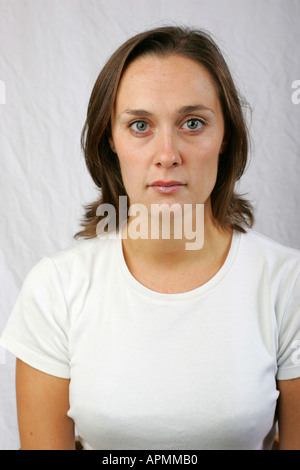 Young brunette woman with emotionless cold unfeeling stoic