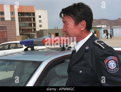 Policeman near the patrol car. Khovd aimak (administrative center). Khovd aimag (province). West Mongolia Stock Photo