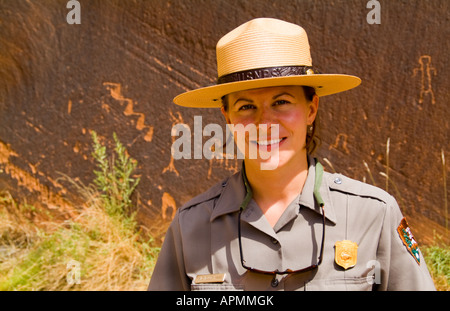 Official National Park Ranger woman at the ancient Petroglyph writings from Indians near Page Arizona in West USA Stock Photo