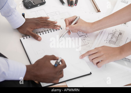 Two architects planning on notepad (focus on hands) Stock Photo