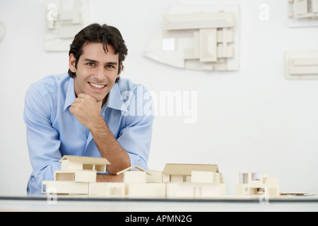 Young architect by model houses (portrait) Stock Photo
