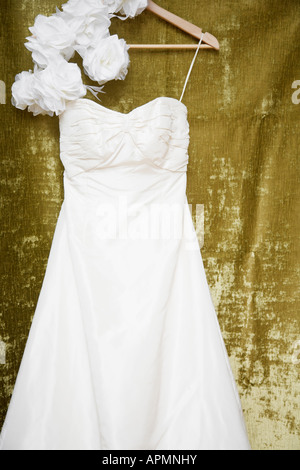 Rose flowers and wedding dress on clothes hanger Stock Photo