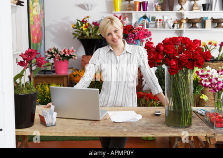 Female florist with laptop (portrait) Stock Photo