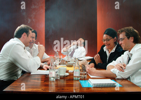 Smoking in boardroom meeting Stock Photo