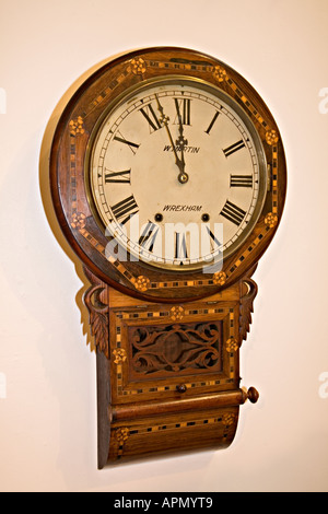 Wall clock with inlaid wood marquetry made in Wrexham Wales UK Stock Photo