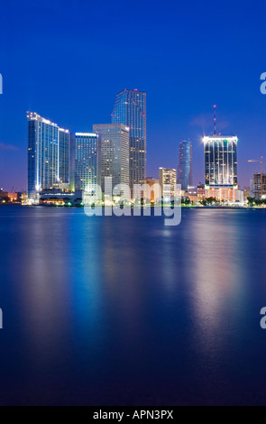 Just before a blue dawn, Biscayne Bay reflects high rise buildings ...