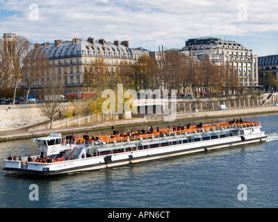 Bateaux Mouches sightseeing cruise boat passes La Samaritaine department store on the River Seine Paris France Europe Stock Photo
