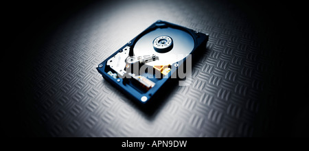 hard drive on industrial footplate background with dramatic spotlighting Stock Photo