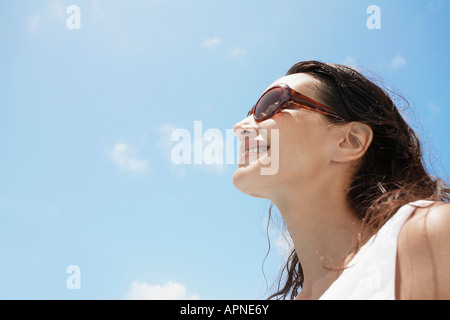 Young woman wearing sunglasses (low angle view)