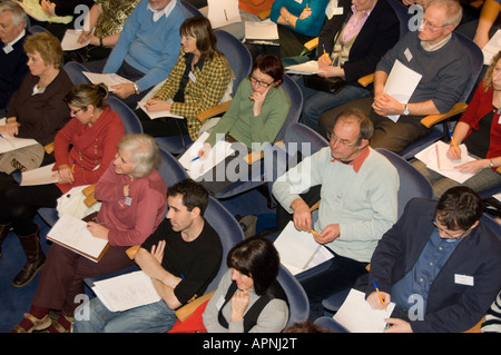small business owners attentively listening and making notes in a seminar on e-commerce and on-line trading Stock Photo