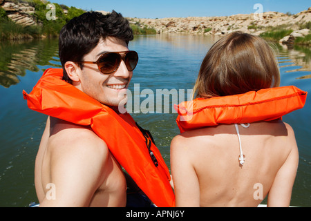 Young couple sailing in life jackets (rear view) Stock Photo